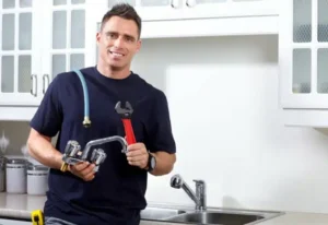 plumber repairing kitchen faucet